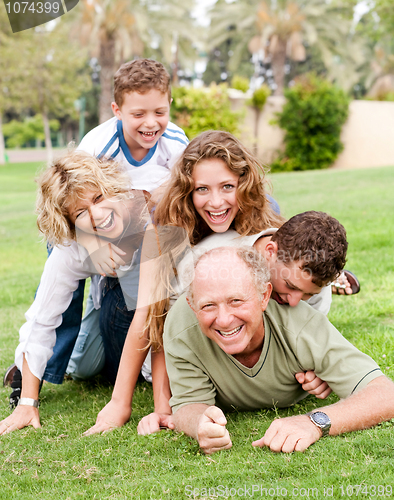 Image of Family piling up on dad