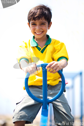 Image of Young kid enjoying swing ride
