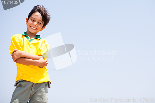 Image of Charming kid posing with folded arms