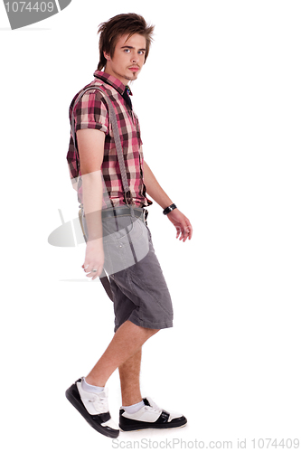 Image of Casual young guy in walking posture