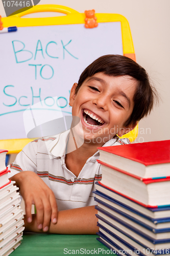 Image of Smiling boy with school books