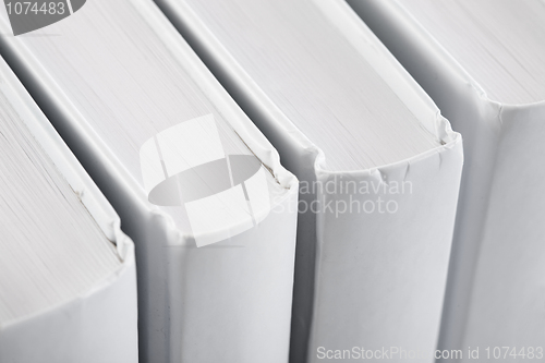 Image of White backs of books close up