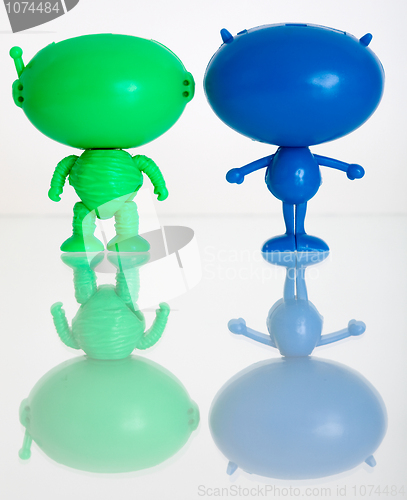 Image of Two figures of aliens on a white