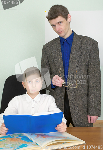 Image of Tutor and schoolgirl with book and atlas