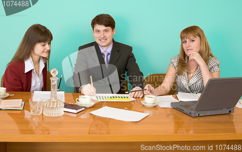 Image of Business team sits at the table