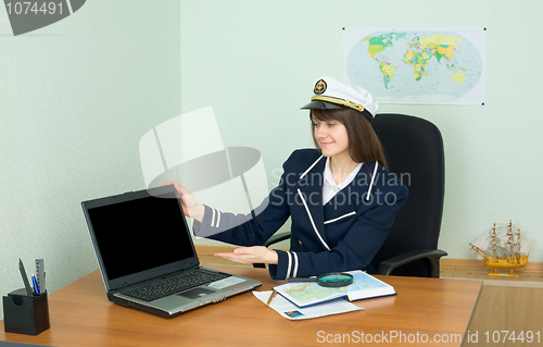 Image of Girl - sea captain at office with laptop