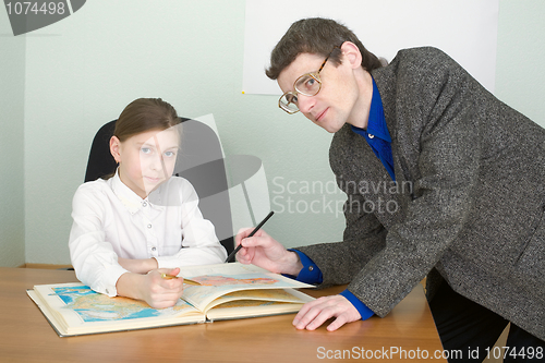 Image of Tutor and schoolgirl with atlas