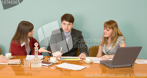 Image of Business team sits at the table