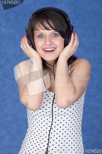Image of Girl listening music in earphones