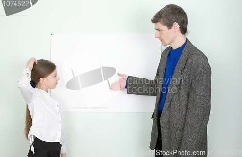 Image of Teacher explains something to the schoolgirl