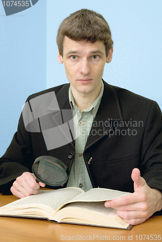 Image of Man read book on a workplace