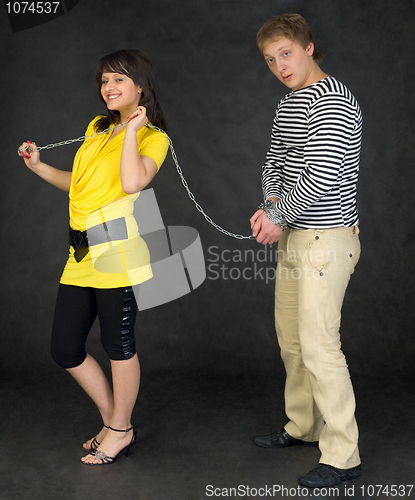 Image of Lady guide shackled young man