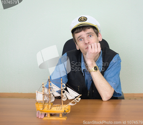 Image of Man with model of a sailing vessel