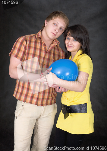 Image of Pair holds on hands a ballon as the baby