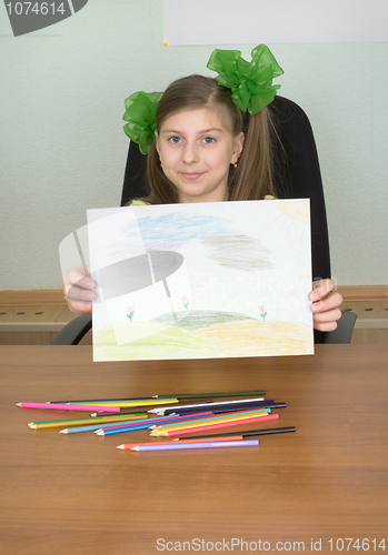 Image of Smiling girl shows new drawing to us