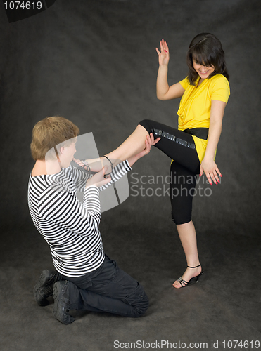 Image of Man kisses to the lady a foot