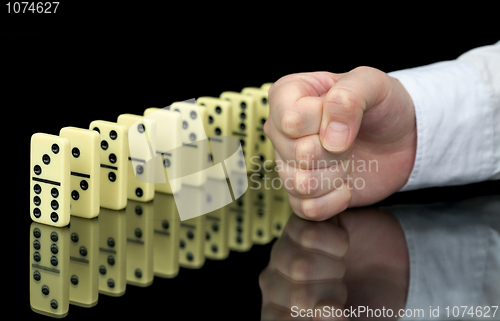 Image of Fist a provoking domino effect