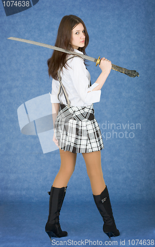 Image of Beautiful girl with japanese sword on a shoulder
