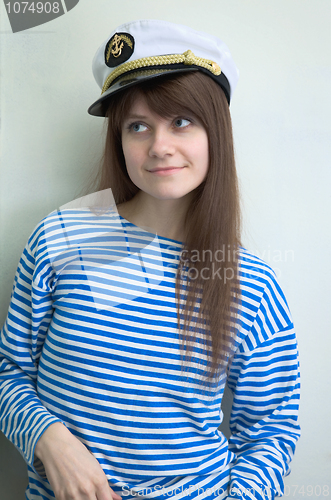 Image of girl in stripped vest and a uniform cap