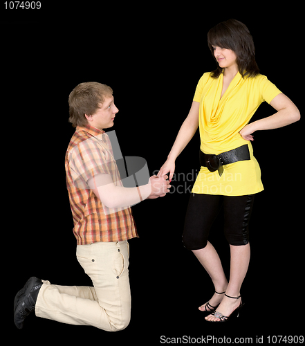 Image of Man is kneeling to the young woman