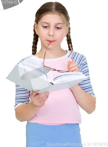 Image of Schoolgirl reads the book on a white