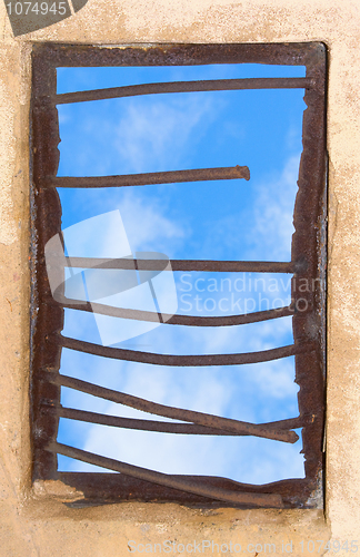 Image of Old window closed by rusty lattice