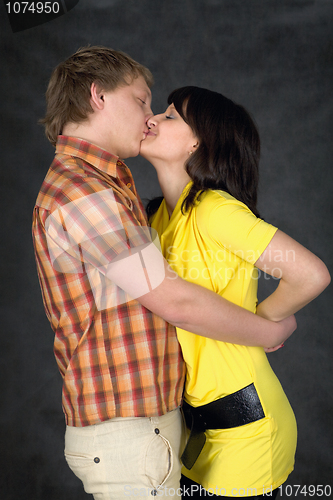 Image of Couple kiss on a black background