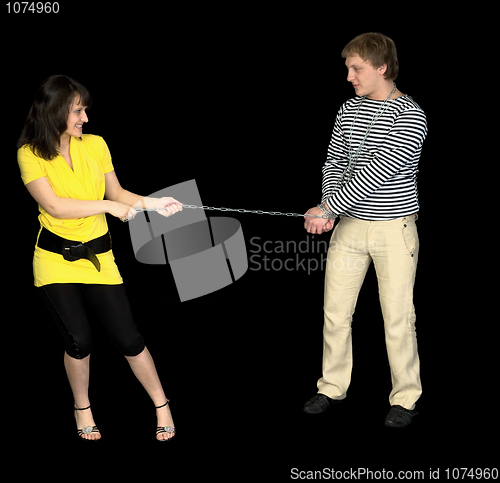 Image of Young girl conducts on a chain of the guy