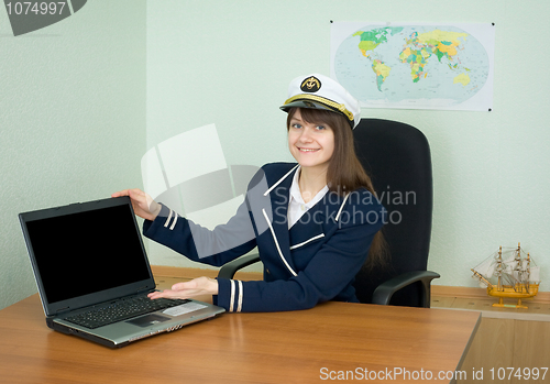 Image of Girl in a sea uniform at office with laptop