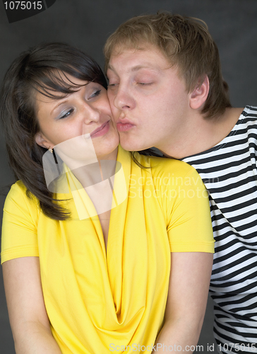 Image of Couple kiss on a black background