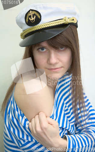 Image of Woman in a stripped vest shows a tattoo