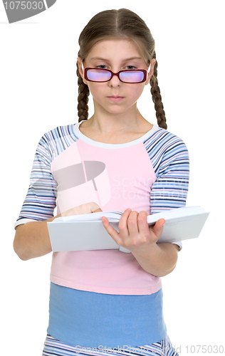Image of Serious schoolgirl with spectacles and book