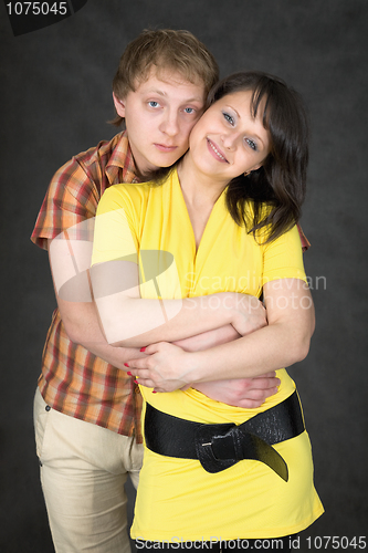 Image of Couple embraces on a black background
