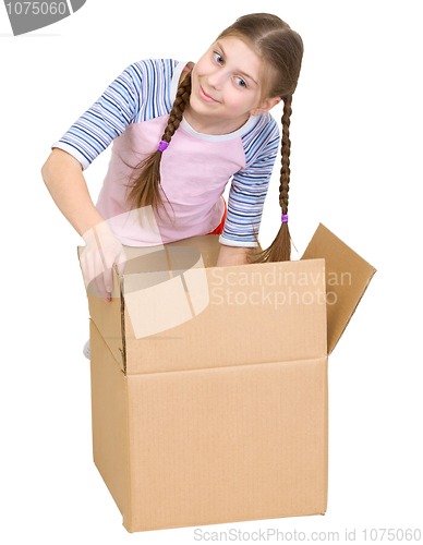 Image of Girl rummages in a cardboard box