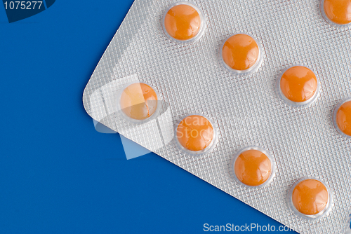 Image of Close-up of a pack of orange pills 