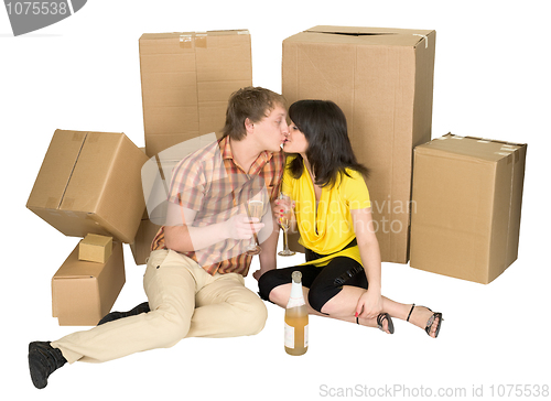 Image of Girl and the guy drink champagne near boxes
