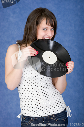 Image of Girl biting a phonograph record on a blue