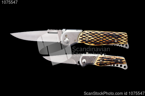 Image of Two pen-knifes on a black background