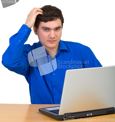 Image of Young man comb head siting for laptop