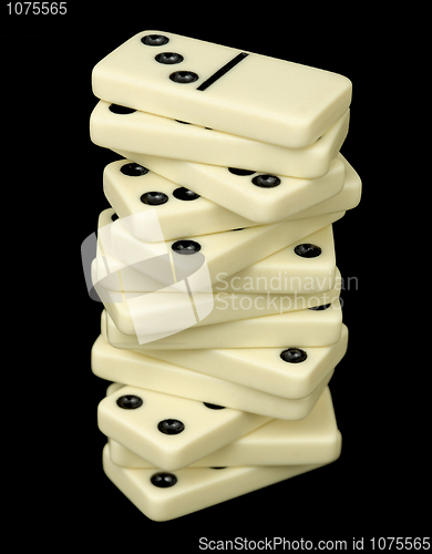 Image of Tower from dominoes bones on a black