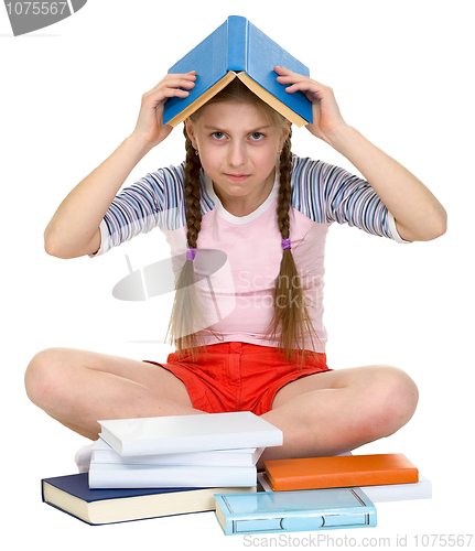 Image of Young girl with book on head