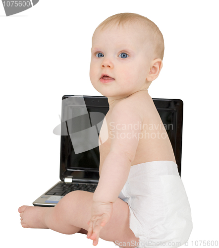 Image of Baby sitting on a white background with laptop