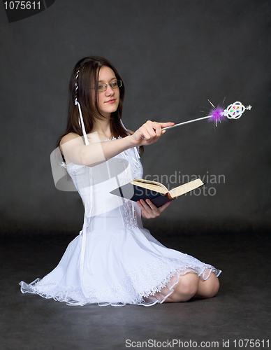 Image of Girl - sorcerer with the book and a magic wand