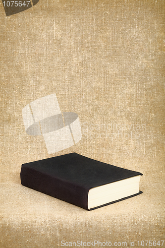 Image of Black book on the fabric background