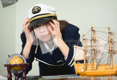 Image of Scared girl in the form of sea captain