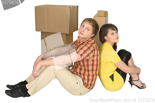 Image of Guy and the girl sit near boxes