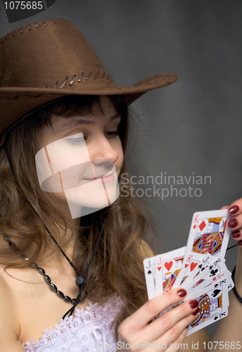 Image of Cowgirl with a playing-cards in hand