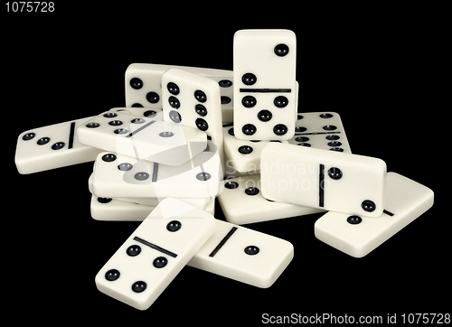 Image of Heap of bones of dominoes on a black