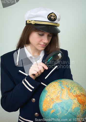 Image of Sea captain looks at the globe