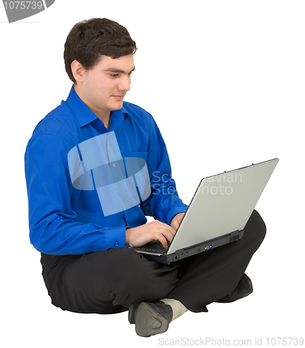 Image of Businessman sits on a floor with the laptop
